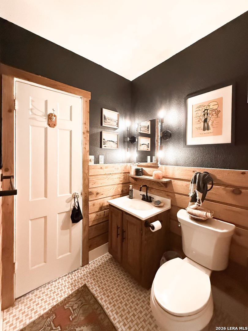 2828 2nd Street Pleasanton, TX 78064 - Photo 20 of 48 a bathroom with a toilet sink and mirror