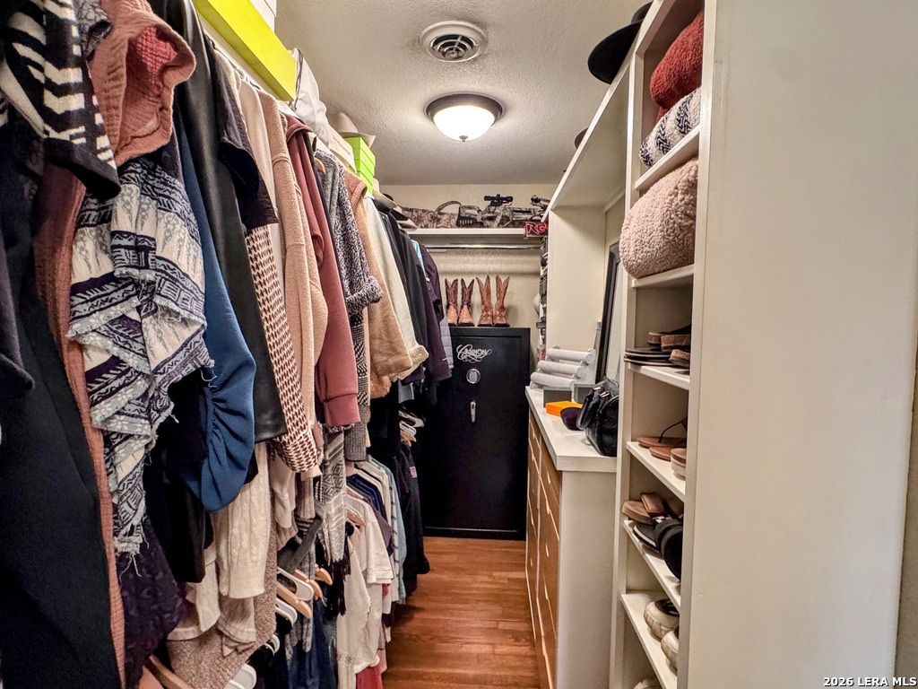 2828 2nd Street Pleasanton, TX 78064 - Photo 26 of 48 a view of walk in closet with clothes and shoes