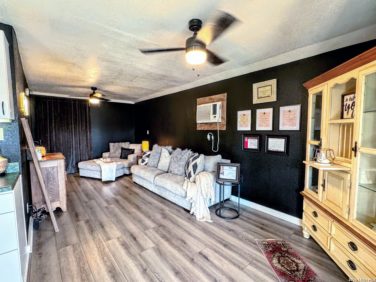 2828 2nd Street Pleasanton, TX 78064 - Photo 36 of 48 a living room with furniture fireplace and wooden floor