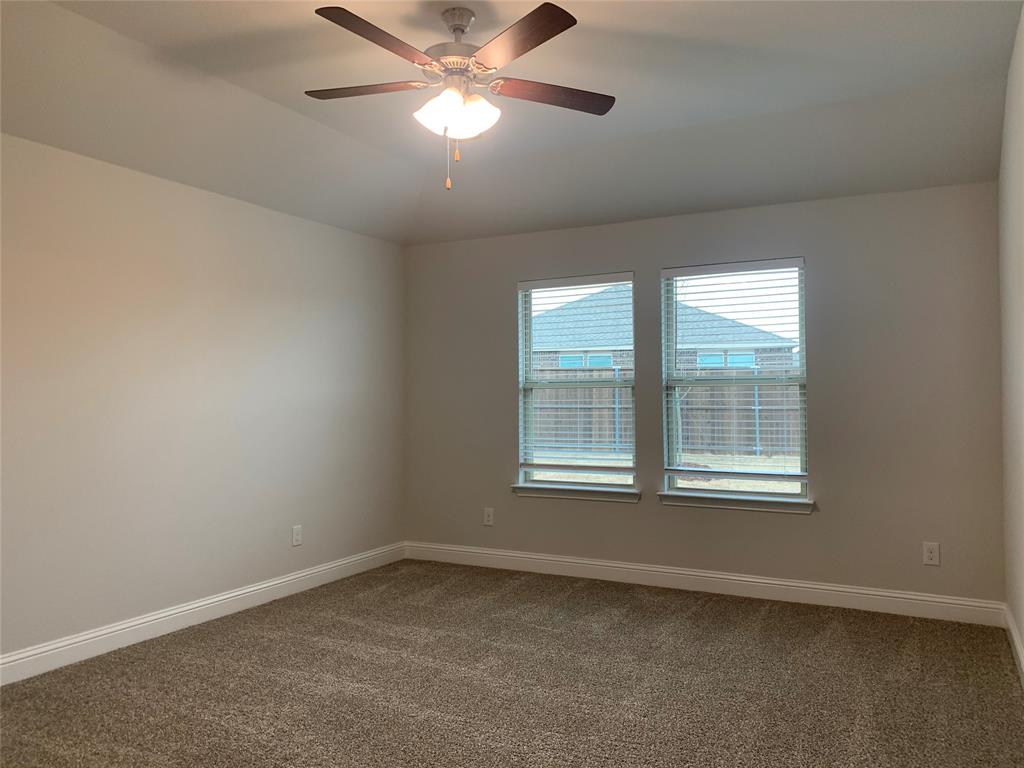 765 Knoxbridge Road Forney, TX 75126 - Photo 14 of 22 an empty room with a window and a fan
