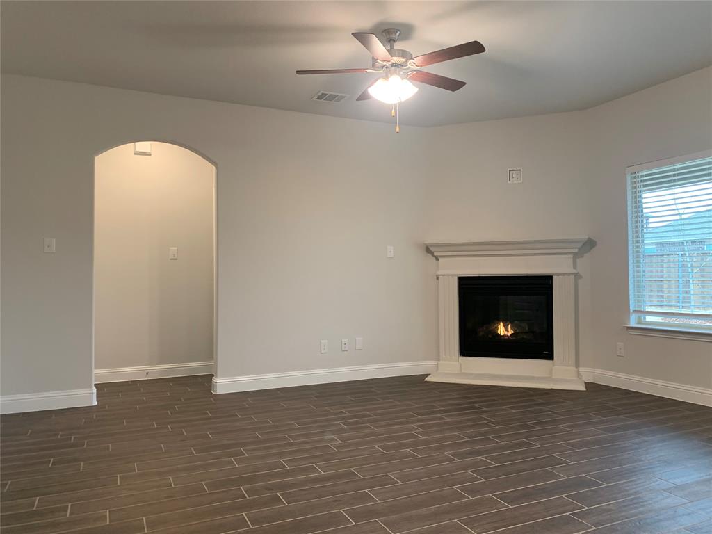 765 Knoxbridge Road Forney, TX 75126 - Photo 7 of 22 an empty room with windows fireplace and a sink