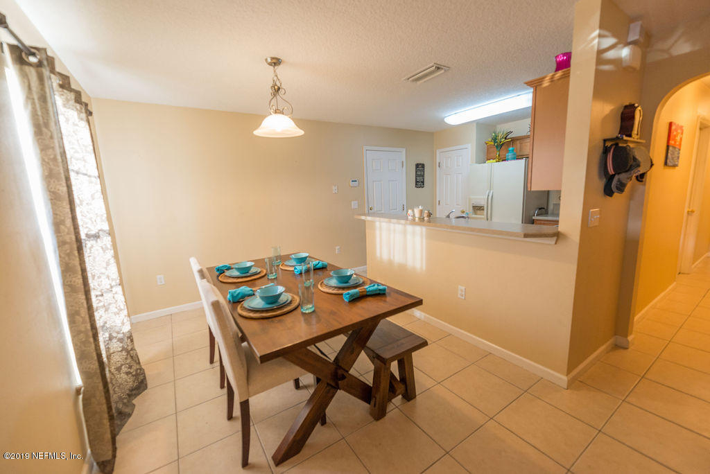 9171 Raptor Drive Jacksonville, FL 32221 - Photo 3 of 13 a view of a dining room with furniture and a chandelier