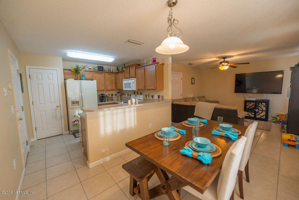 9171 Raptor Drive Jacksonville, FL 32221 - Photo 13 of 13 a view of a dining room with furniture and a chandelier