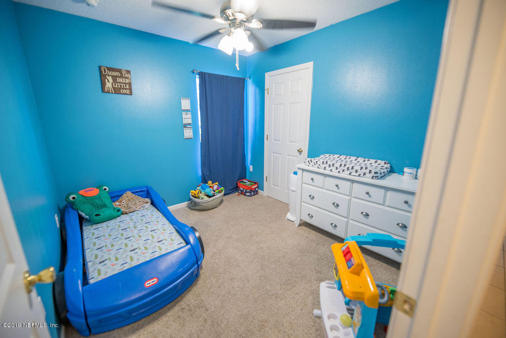 9171 Raptor Drive Jacksonville, FL 32221 - Photo 6 of 13 a living room with furniture and a table