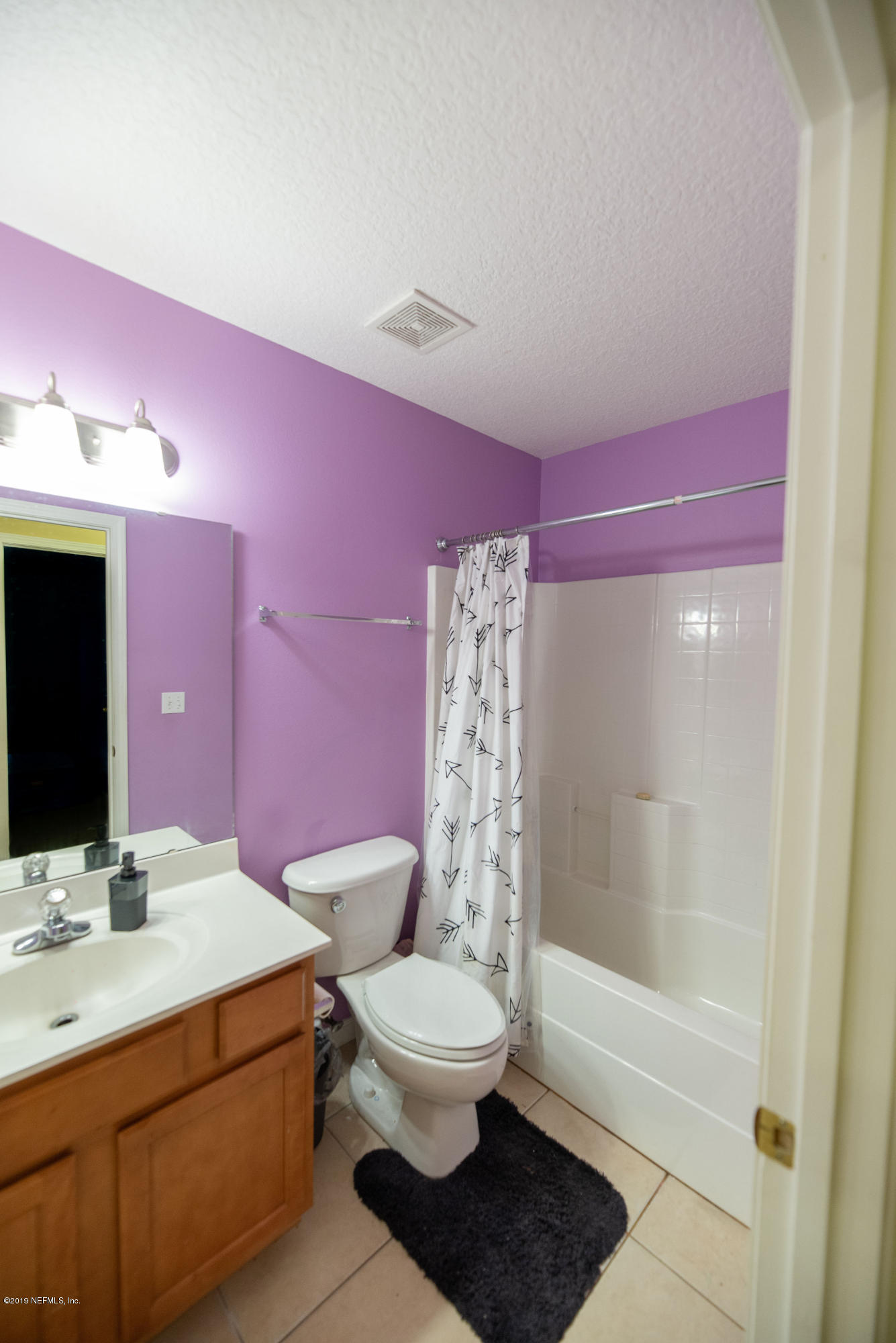 9171 Raptor Drive Jacksonville, FL 32221 - Photo 8 of 13 a bathroom with a sink a toilet a mirror and shower