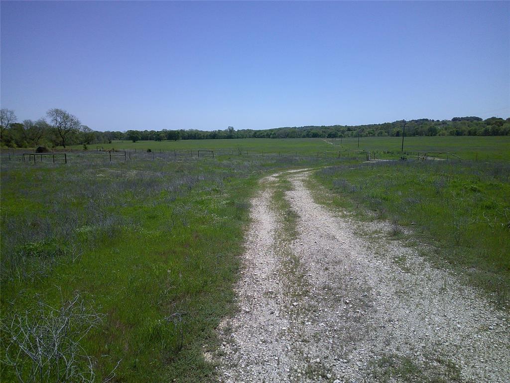 55-ac Starr Mann Road St. Jo, TX 76265 - Photo 2 of 9 a view of a lake with a house in the background