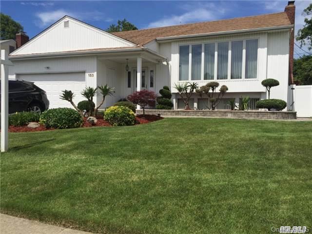 153 Roxton Road Plainview, NY 11803 - Photo 1 of 1 a front view of small house with yard and outdoor seating