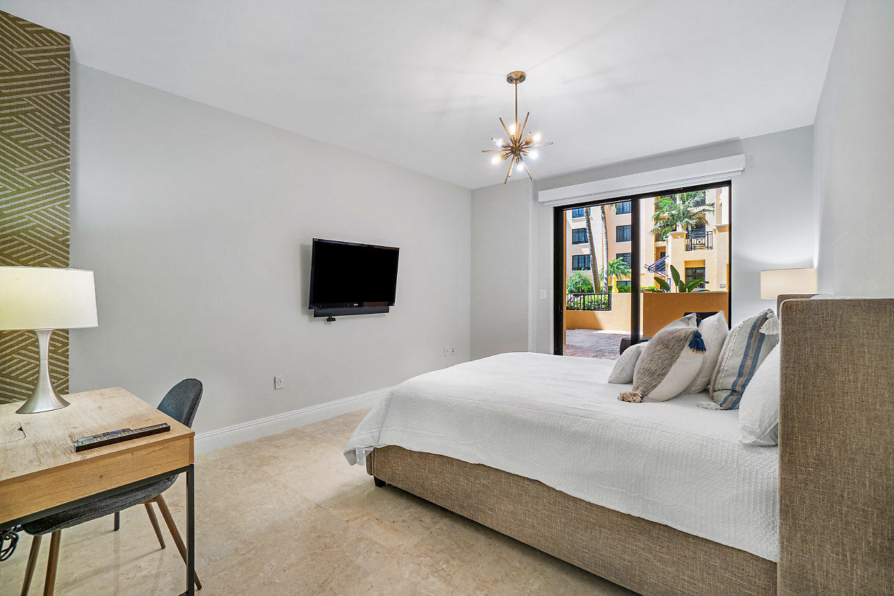200 East Palmetto Park Road, Unit 410 Boca Raton, FL 33432 - Photo 15 of 44 a bedroom with a bed window and a flat screen tv