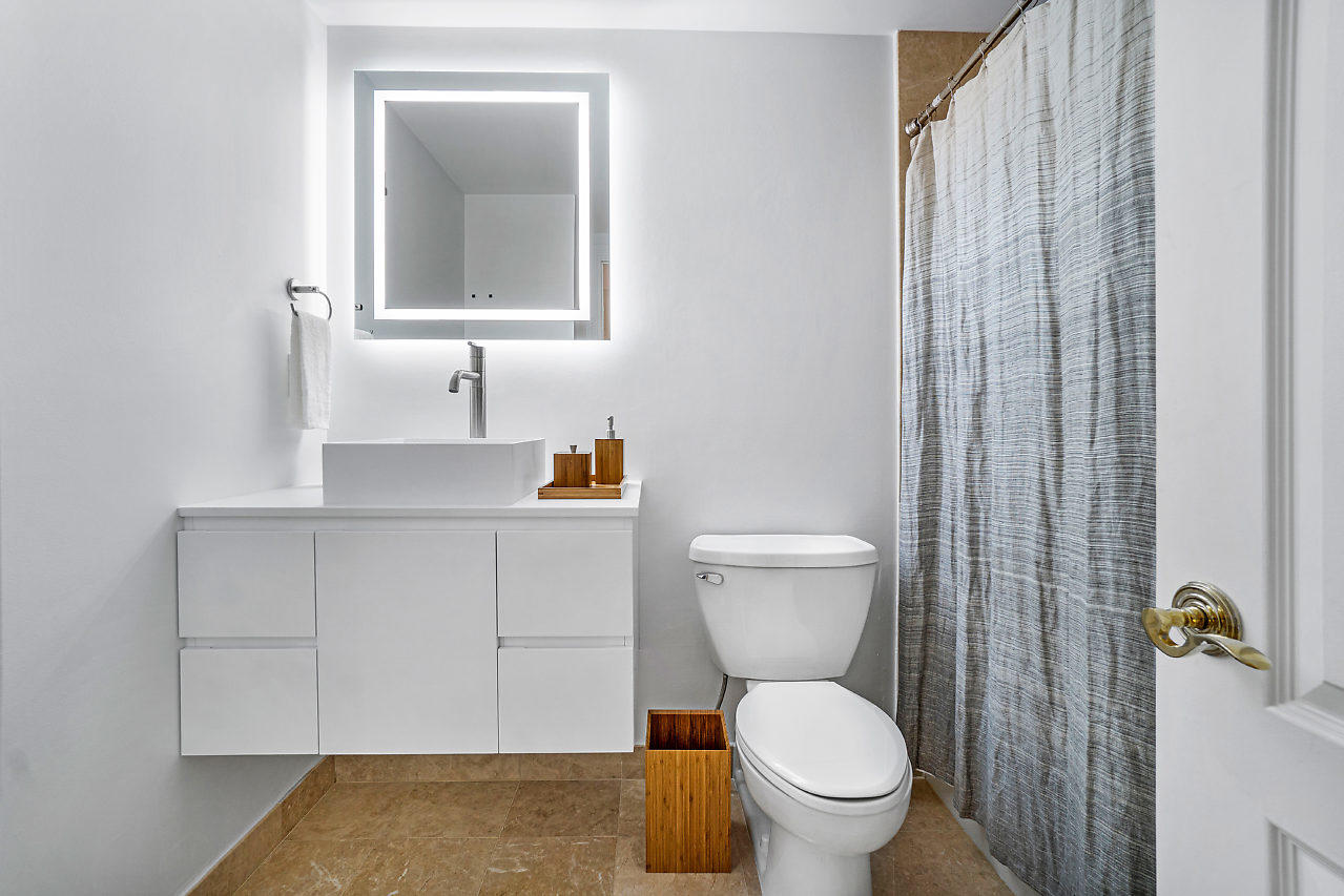 200 East Palmetto Park Road, Unit 410 Boca Raton, FL 33432 - Photo 17 of 44 a bathroom with a toilet a sink and a window