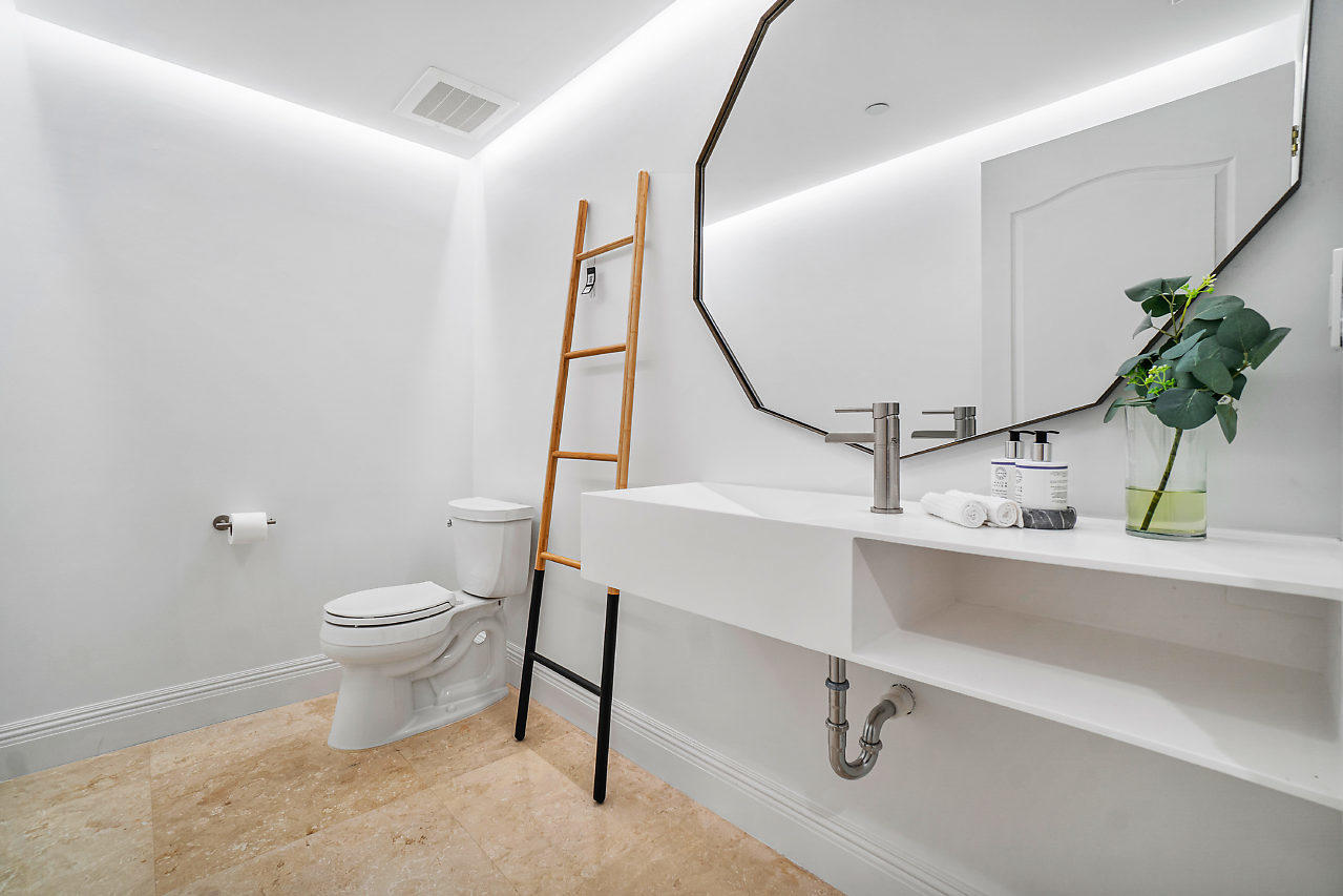 200 East Palmetto Park Road, Unit 410 Boca Raton, FL 33432 - Photo 19 of 44 a bathroom with a sink a toilet and a mirror