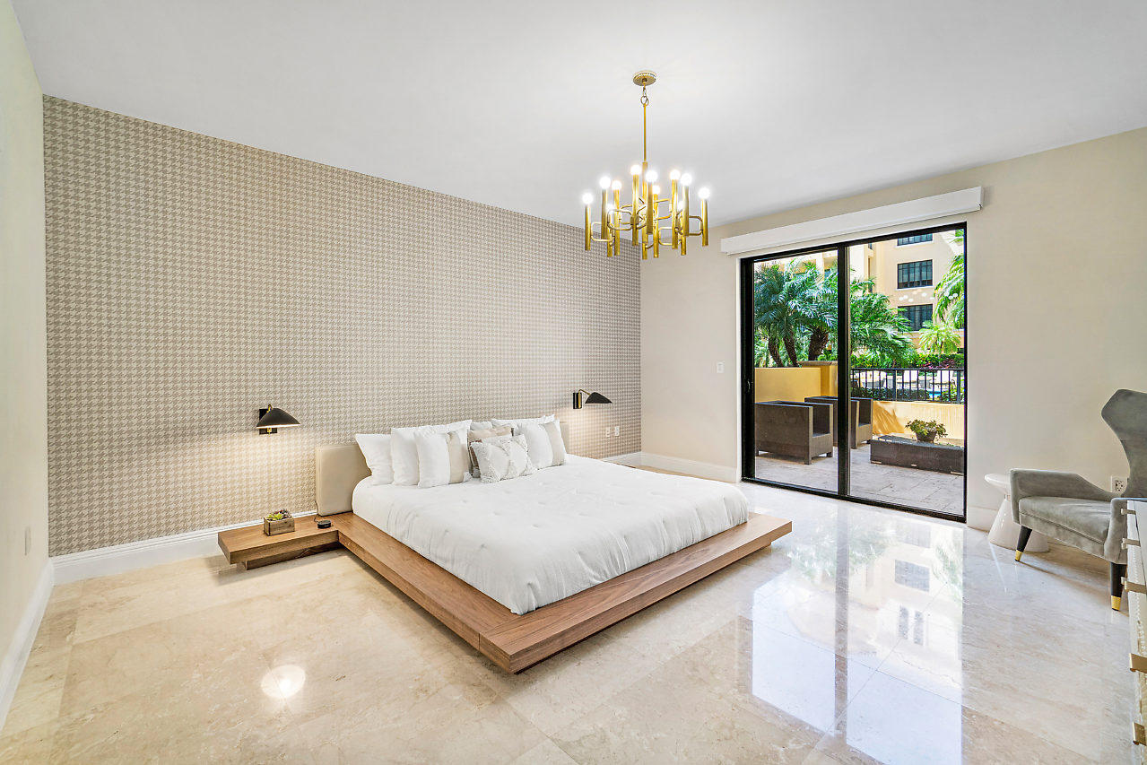 200 East Palmetto Park Road, Unit 410 Boca Raton, FL 33432 - Photo 20 of 44 a bedroom with a bed chandelier and a window