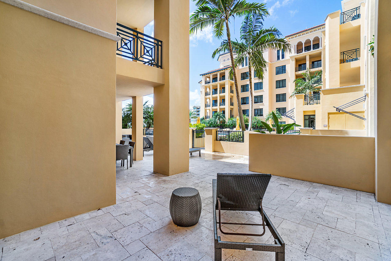 200 East Palmetto Park Road, Unit 410 Boca Raton, FL 33432 - Photo 28 of 44 a view of a patio with a table and chairs and potted plants