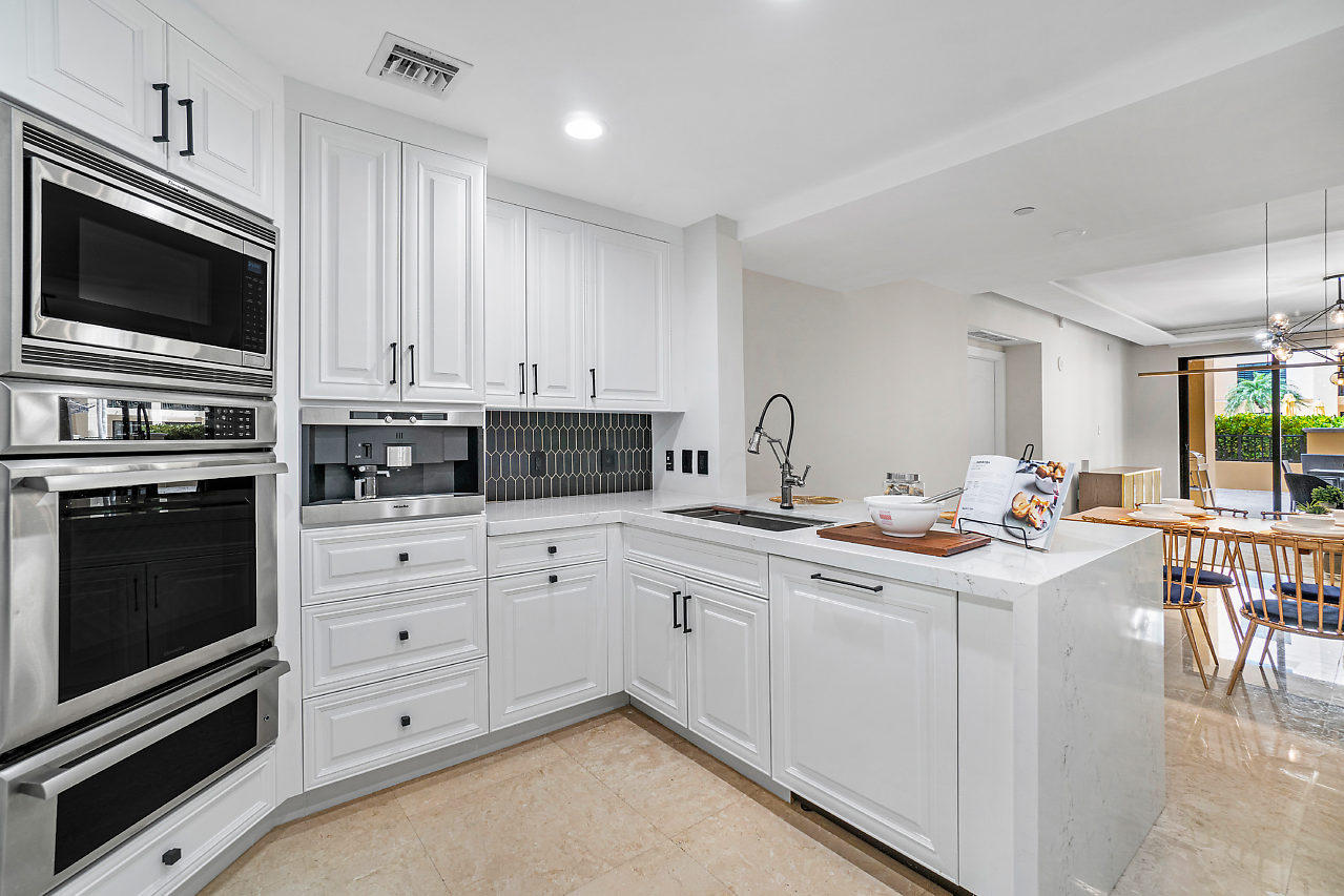 200 East Palmetto Park Road, Unit 410 Boca Raton, FL 33432 - Photo 7 of 44 a kitchen with stainless steel appliances a stove a sink and a microwave