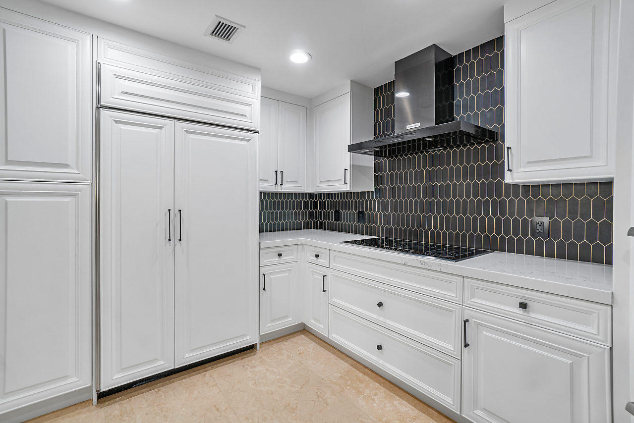 200 East Palmetto Park Road, Unit 410 Boca Raton, FL 33432 - Photo 8 of 44 a kitchen with granite countertop white cabinets and stainless steel appliances