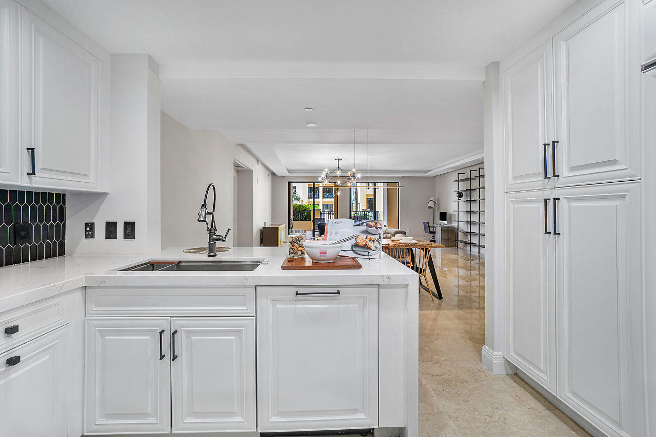 200 East Palmetto Park Road, Unit 410 Boca Raton, FL 33432 - Photo 9 of 44 a kitchen with white cabinets and sink