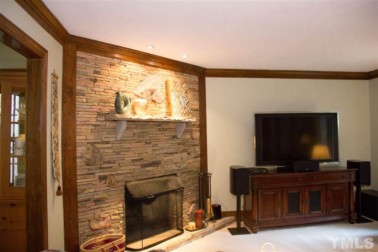 2500 Saddleridge Drive Raleigh, NC 27615 - Photo 6 of 25 a living room with a fireplace and a flat screen tv