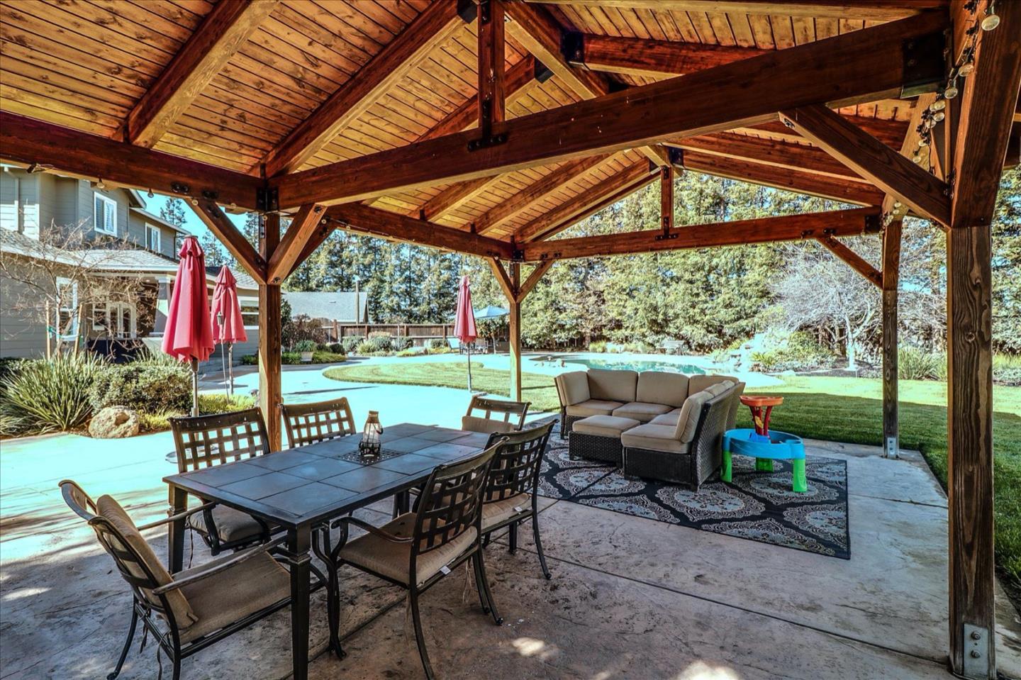 6061 Leedom Road Hughson, CA 95326 - Photo 44 of 48 a view of patio with table and chairs potted plants and large tree