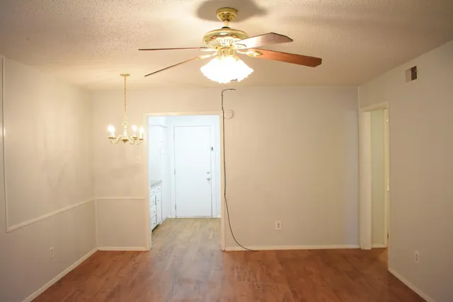 a view of a room with wooden floor