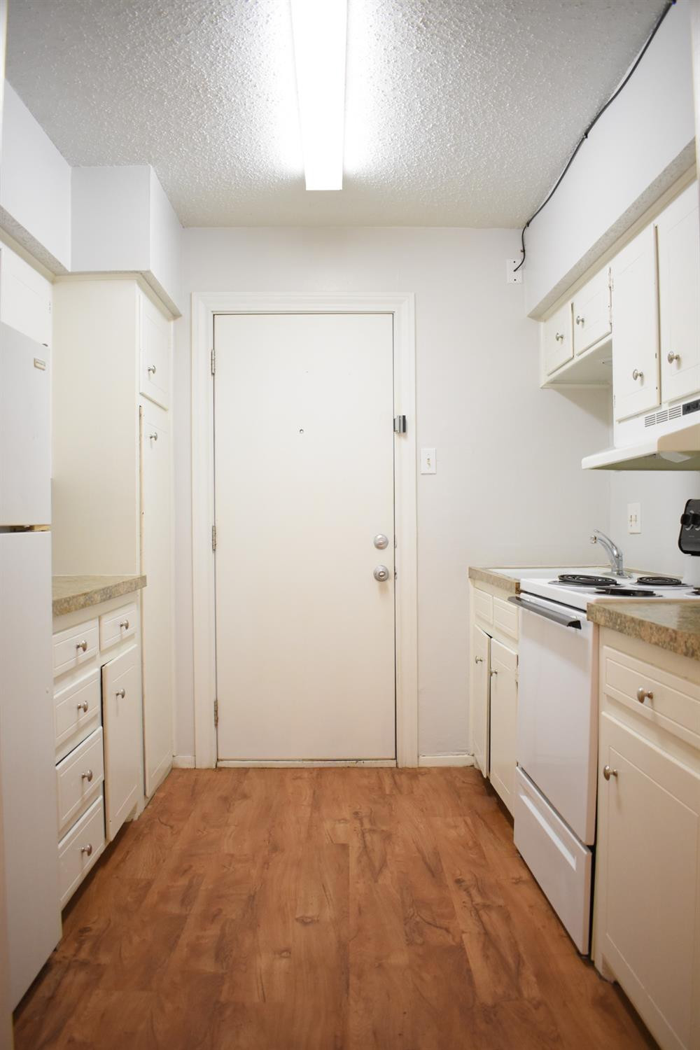 3414 Nashville Avenue, Unit C Lubbock, TX 79413 - Photo 4 of 8 a view of a kitchen with white cabinets