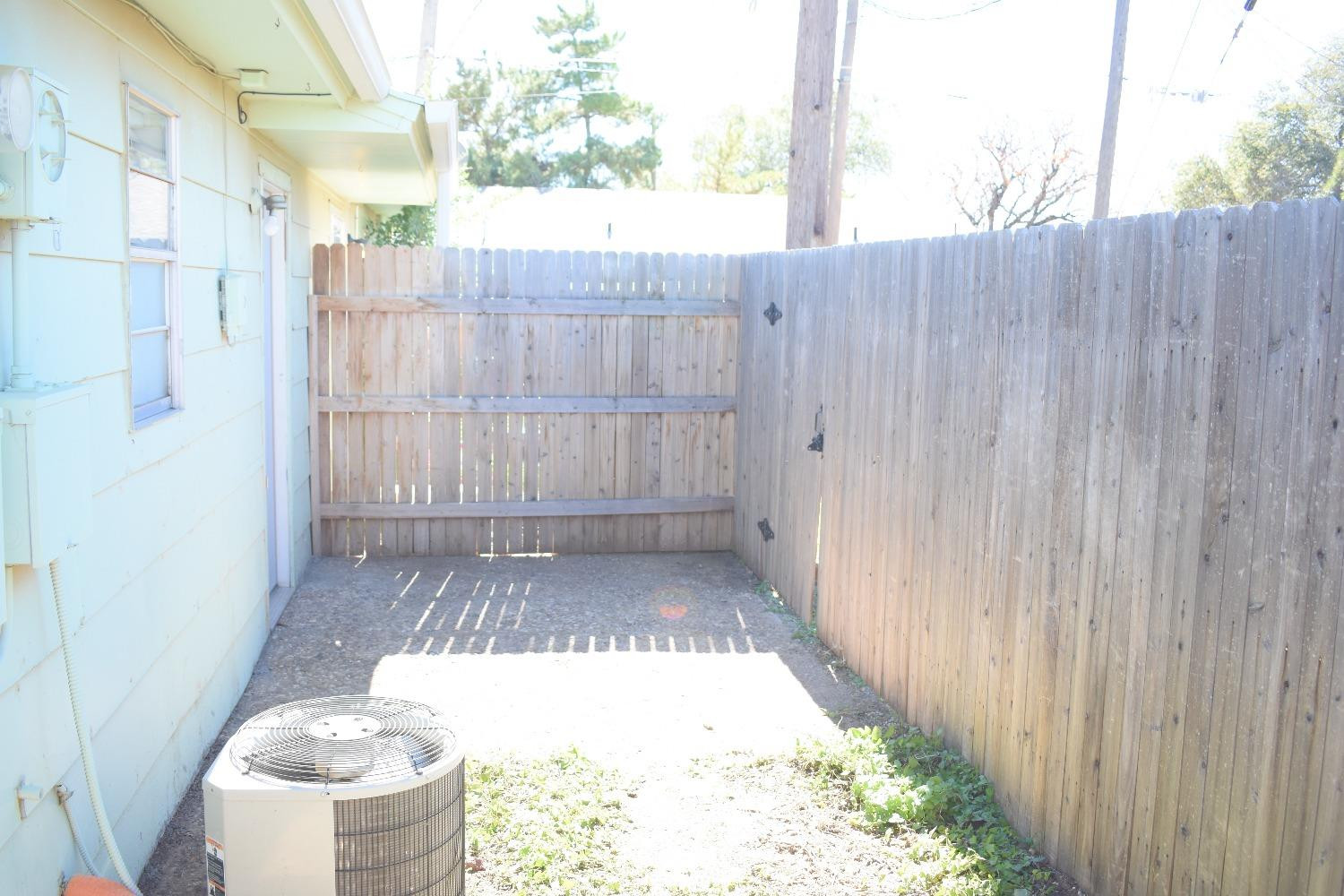 3414 Nashville Avenue, Unit C Lubbock, TX 79413 - Photo 8 of 8 a view of a backyard with table and chairs