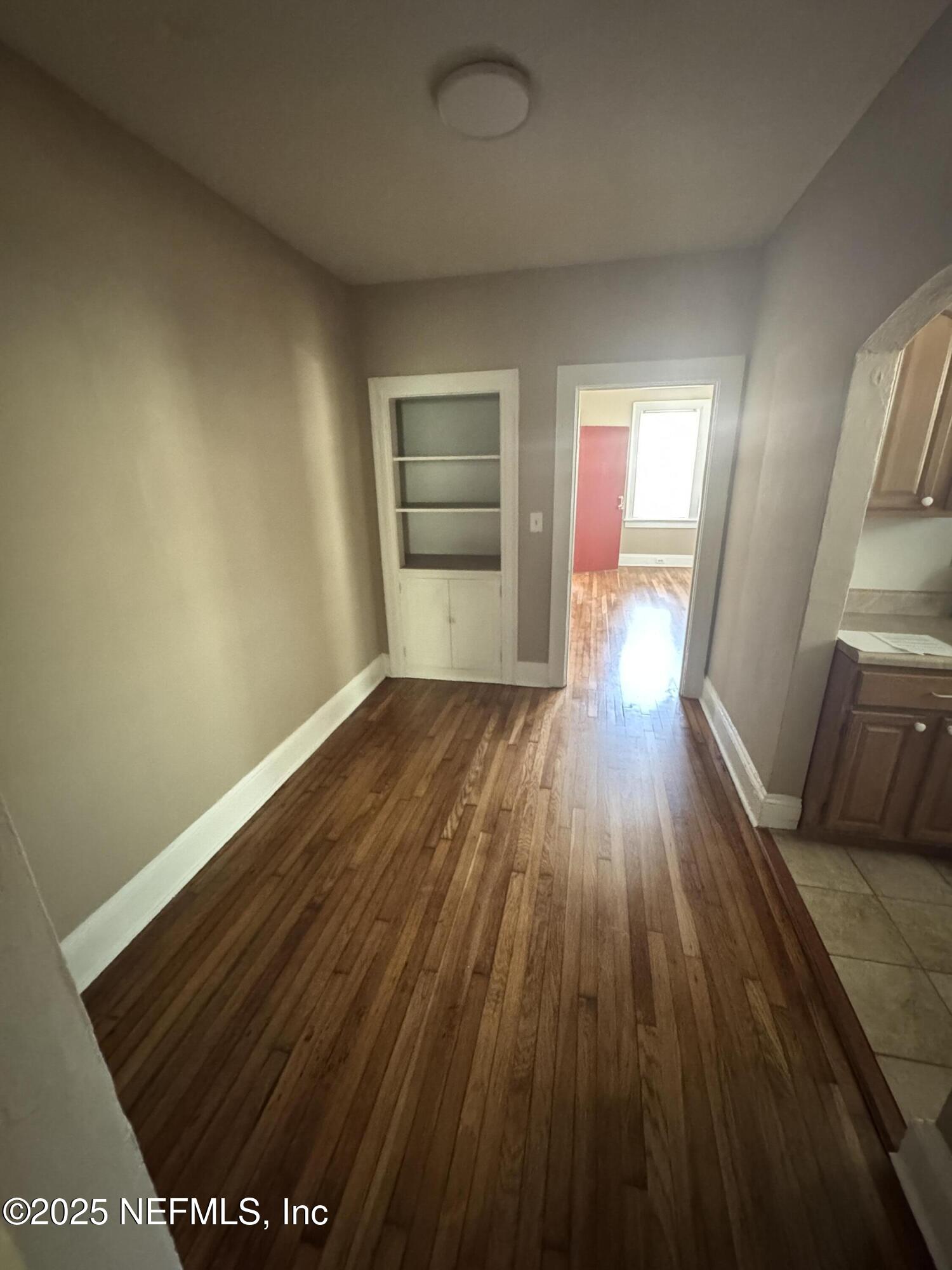 2056 Post Street, Unit 1 Jacksonville, FL 32204 - Photo 6 of 10 a view of a room with wooden floor and staircase