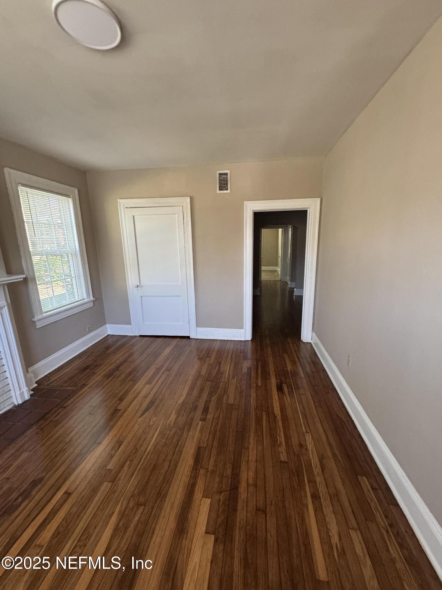 2056 Post Street, Unit 1 Jacksonville, FL 32204 - Photo 7 of 10 a view of an empty room with wooden floor and a window