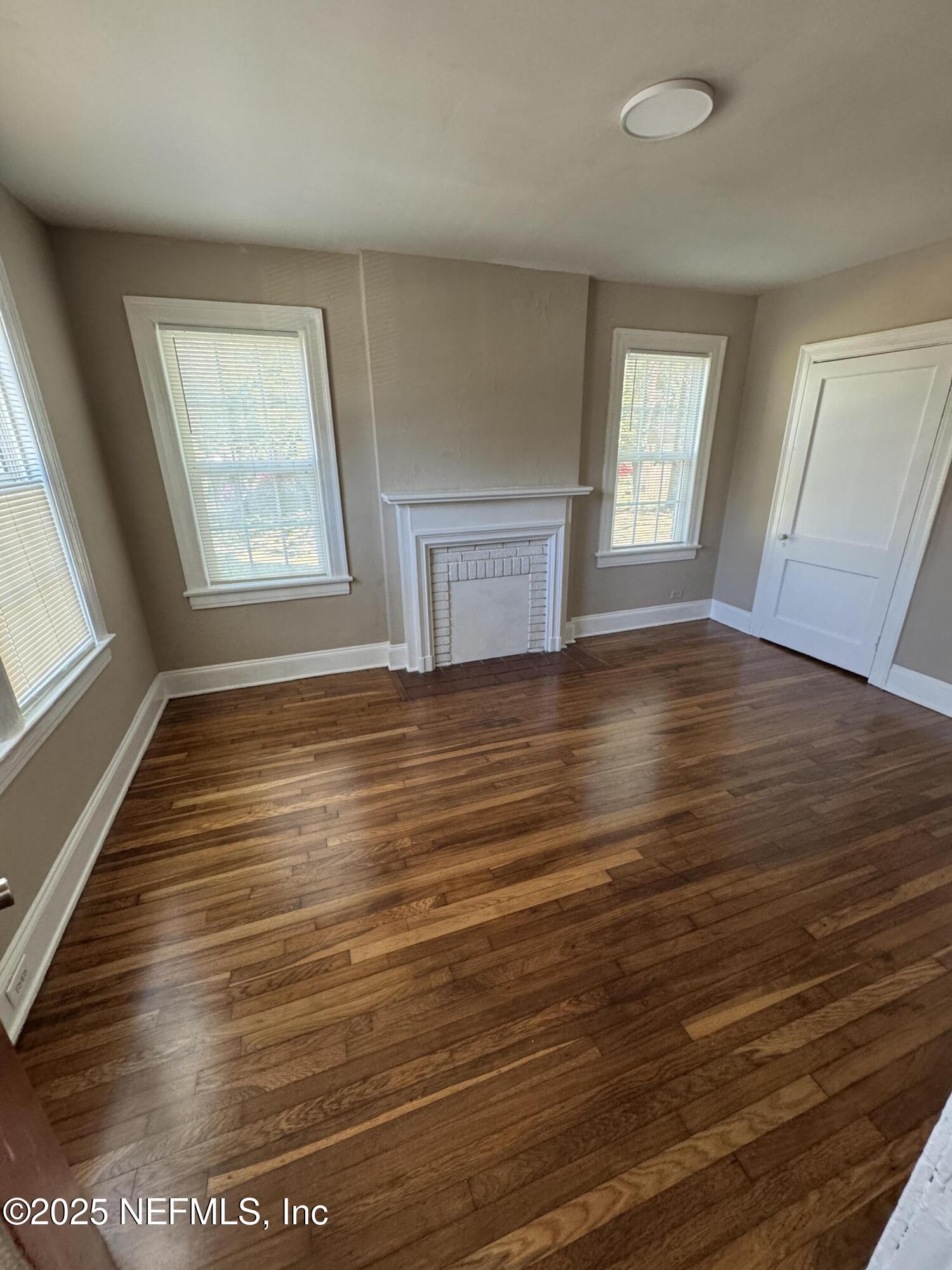 2056 Post Street, Unit 1 Jacksonville, FL 32204 - Photo 8 of 10 a view of an empty room with wooden floor and a window