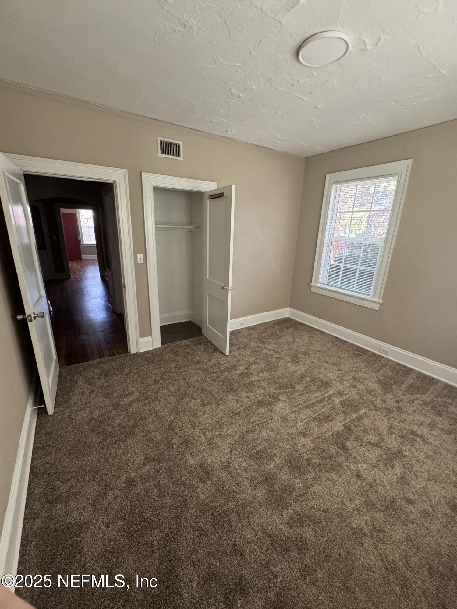 2056 Post Street, Unit 1 Jacksonville, FL 32204 - Photo 10 of 10 an empty room with windows and closet
