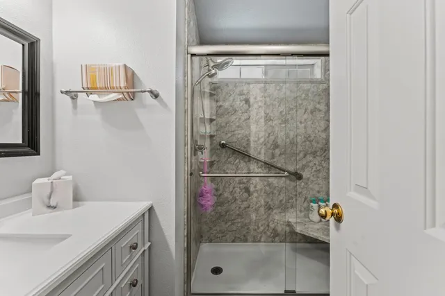 a bathroom with a shower and a sink
