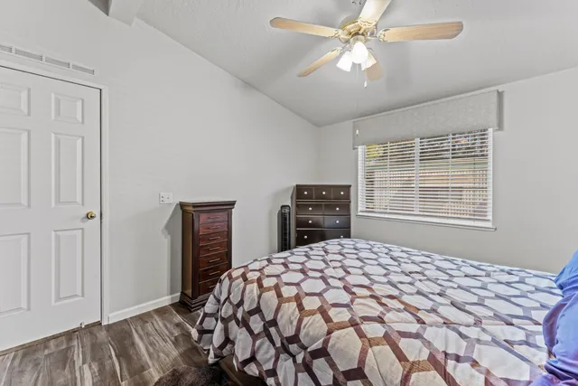 a bedroom with a large bed and a chandelier