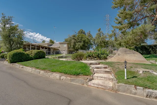 a view of a street with a house in the background