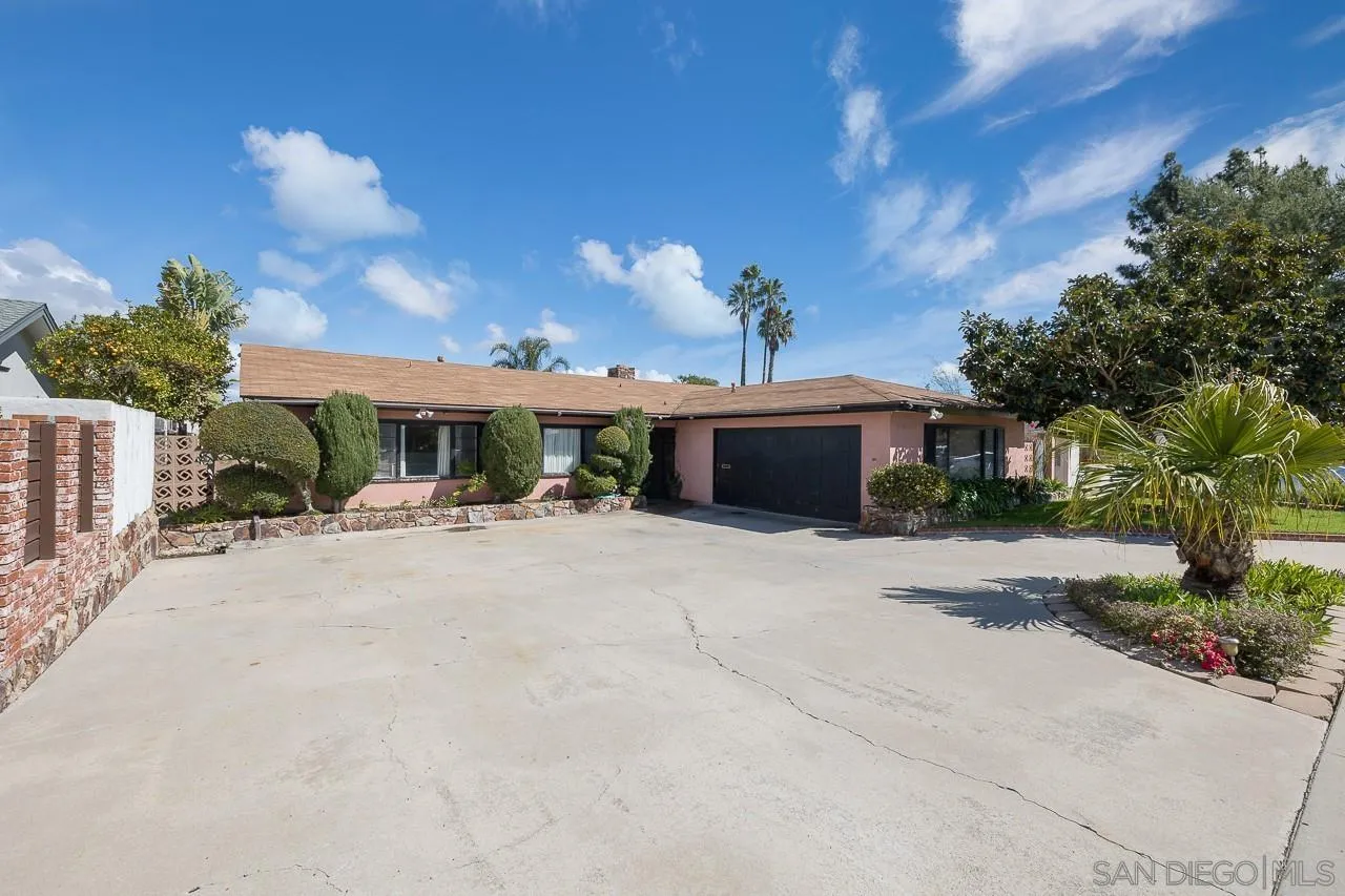 a front view of a house with a yard and a garage
