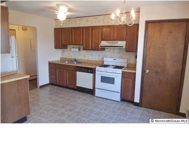 1204 River Road, Unit 1/2 B Belmar, NJ 07719 - Photo 4 of 19 a kitchen with kitchen island granite countertop a sink stainless steel appliances and cabinets