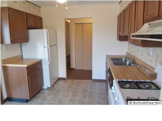 1204 River Road, Unit 1/2 B Belmar, NJ 07719 - Photo 5 of 19 a kitchen with a refrigerator and a stove top oven
