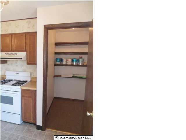 1204 River Road, Unit 1/2 B Belmar, NJ 07719 - Photo 6 of 19 a kitchen with a stove and a refrigerator