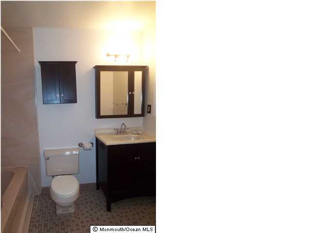 1204 River Road, Unit 1/2 B Belmar, NJ 07719 - Photo 10 of 19 a bathroom with a toilet sink and mirror