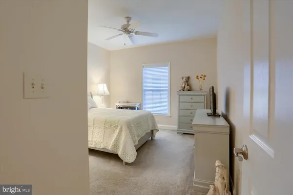 a bedroom with a bed and ceiling fan