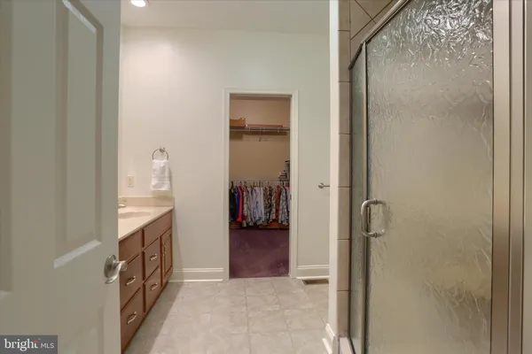 a en suite bathroom with a granite countertop sink and a mirror