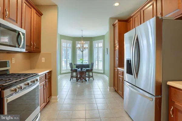 a kitchen with stainless steel appliances granite countertop a refrigerator stove and sink