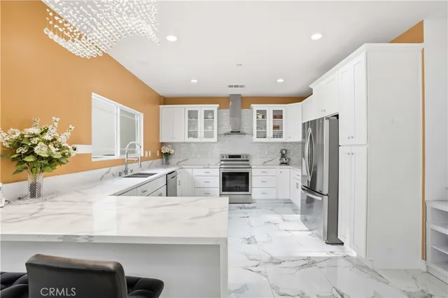 a kitchen with stainless steel appliances cabinets and a window