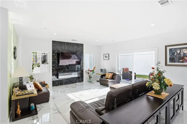 a kitchen with stainless steel appliances kitchen island granite countertop a refrigerator and a stove top oven