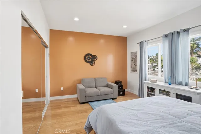 a view of a hallway with wooden floor and entryway