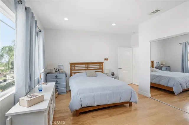 a view of a hallway with furniture and a window
