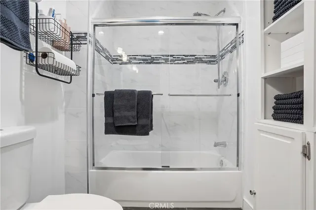 a kitchen with stainless steel appliances cabinets a stove a sink and a window