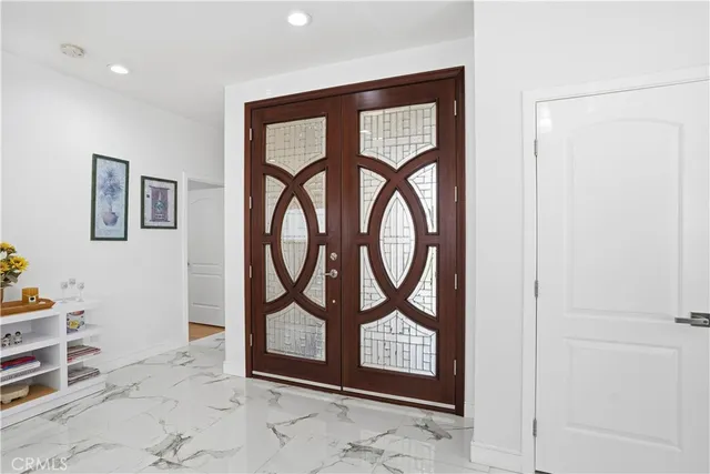 a dining room with stainless steel appliances a table and chairs
