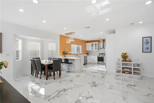 a living room with furniture a dining table and a flat screen tv