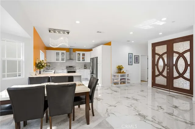 a kitchen with a refrigerator and a stove top oven