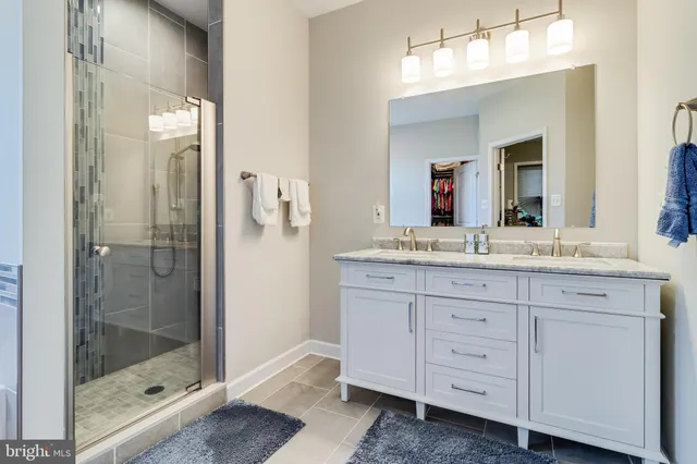 a bathroom with a shower sink and mirror