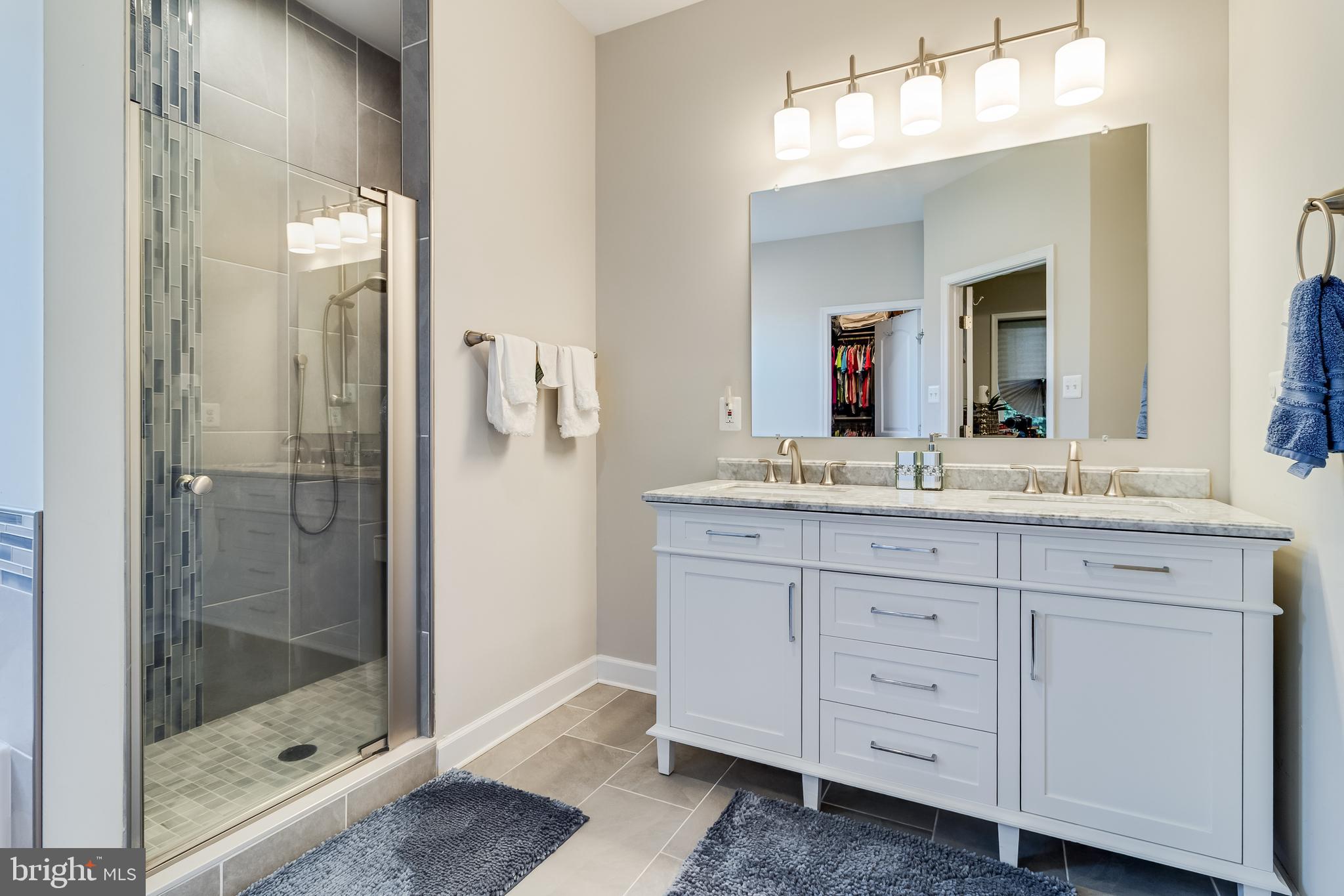 6925 Rock Spring Place Bryans Road, MD 20616 - Photo 19 of 32 a bathroom with a shower sink and mirror