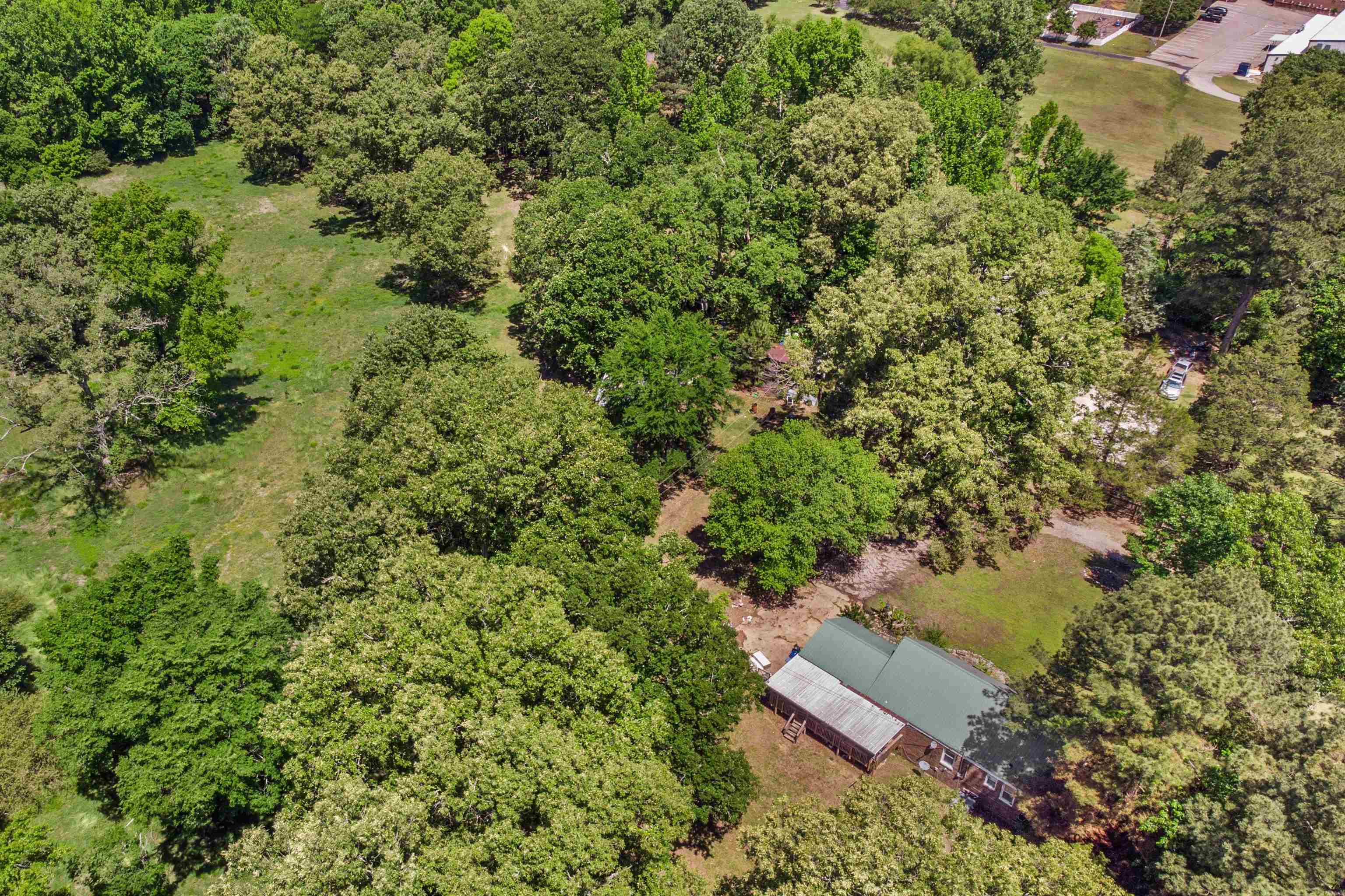 1147 North Collierville Arlington Road Collierville, TN 38017 - Photo 13 of 17 Wood-sided residence featuring a green metal roof